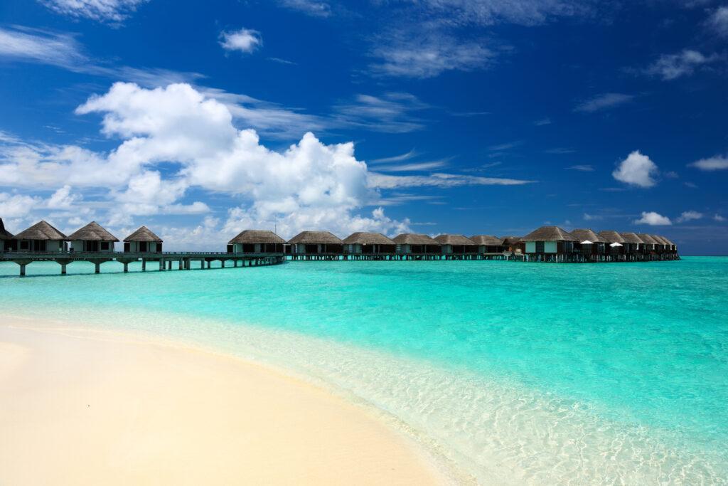 Resort de luxe aux Maldives avec villas sur pilotis et plage de sable blanc