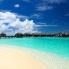 Resort de luxe aux Maldives avec villas sur pilotis et plage de sable blanc